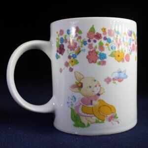 Three Playful Bunnies Cavort on a Colorful Easter Mug by Houston Foods